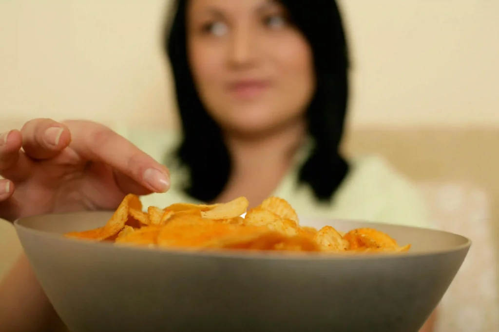 Person eating chips Image Image