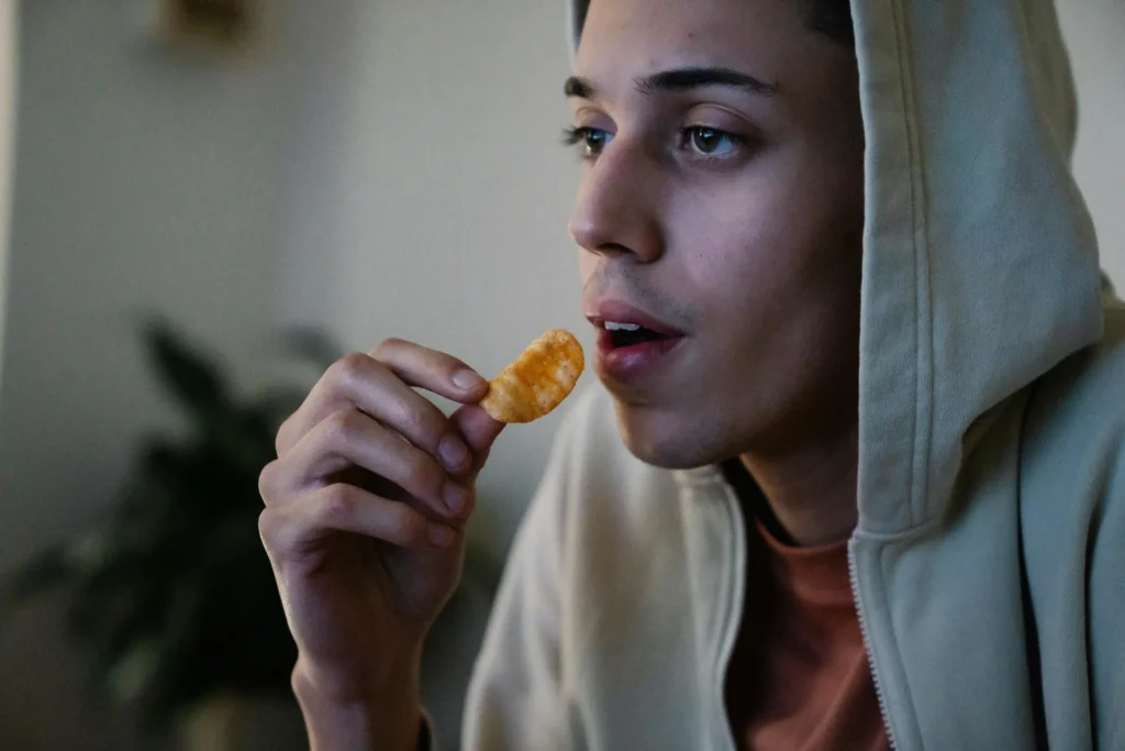 Person eating chips Image